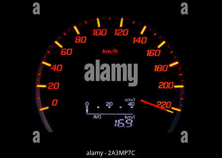 Close up of car speedometer with the needle pointing a high speed at blackground, Speedometer with a red arrow indicating speeding, conceptual image f Stock Photo