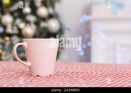 Merry Christmas. Decorated room no people cup of milk and cookies on table close-up Stock Photo