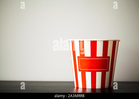 Striped box with popcorn on wood desk Stock Photo