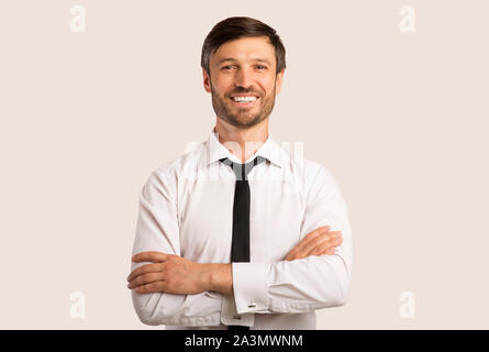 Business Guy Smiling Crossing Hands Standing Over White Background Stock Photo