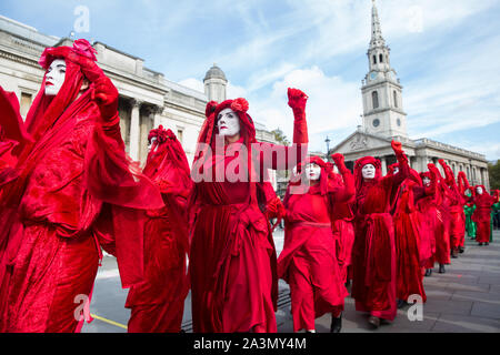 London, UK. 9 October, 2019. Climate activists from the Extinction Rebellion Red Brigade gather in Trafalgar Square on the third day of International Rebellion protests to demand a government declaration of a climate and ecological emergency, a commitment to halting biodiversity loss and net zero carbon emissions by 2025 and for the government to create and be led by the decisions of a Citizens’ Assembly on climate and ecological justice. Credit: Mark Kerrison/Alamy Live News Stock Photo