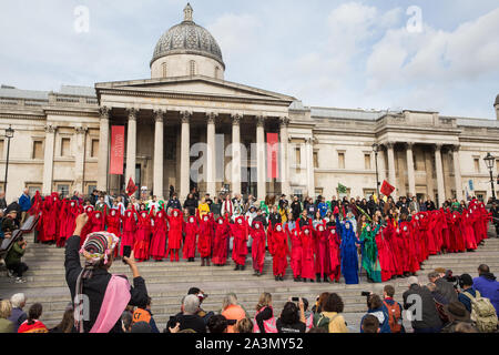 London, UK. 9 October, 2019. Climate activists from the Extinction Rebellion Red Brigade gather in Trafalgar Square on the third day of International Rebellion protests to demand a government declaration of a climate and ecological emergency, a commitment to halting biodiversity loss and net zero carbon emissions by 2025 and for the government to create and be led by the decisions of a Citizens’ Assembly on climate and ecological justice. Credit: Mark Kerrison/Alamy Live News Stock Photo