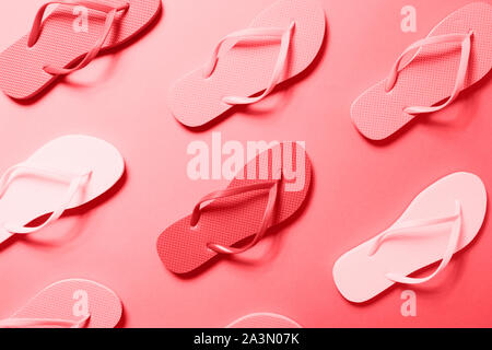 Multicolor flip flops on the solid background toned in trendy seasonal color, monochrome image. Horizontal Stock Photo