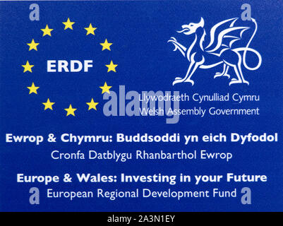 ERDF bilingual sign European Regional Development Fund Welsh Assembly Government notice at a recipient property in Wales UK Stock Photo