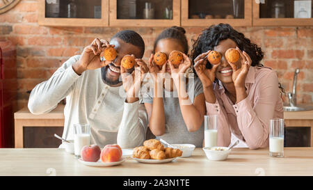 Joyful family having fun during breakfast at kitchen Stock Photo