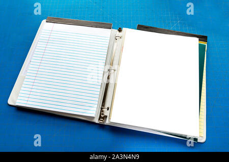 Horizontal shot of an Open Notebook With Copy Space Against Blue Cutting Board Background. Stock Photo