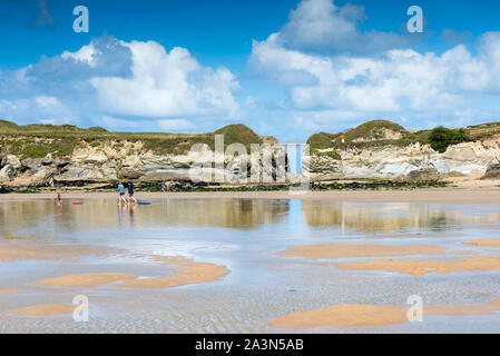 The footbridge connecting the mainland with Porth Island at Porth Beach in Newquay in Cornwall. Stock Photo