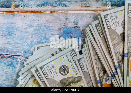 Sign money cash american dollars of one hundred US banknotes in the blue old wooden background Stock Photo