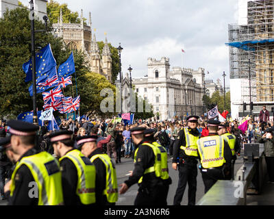 A large group of Extinction Rebellion demonstrators arrived with their drums. The policemen form a line to keep everyone on one side. Stock Photo
