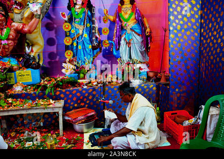 Chanda Bazar, North 24 Parganas, India, 6th October, 2019 :  Hindu priest. Pundit, Brahman reading Hindu mantra in a pandal performing rituals of Puja Stock Photo