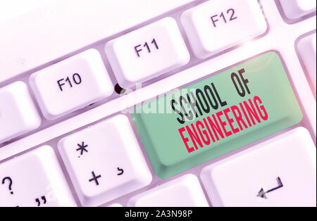 Text sign showing School Of Engineering. Business photo text college to study mechanical communication subjects White pc keyboard with empty note pape Stock Photo