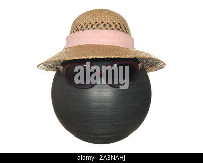 Lady's straw hat with pink ribbon and dark safety glasses on a black plastic ball isolated on a white background. Stock Photo