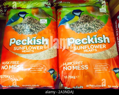 A stack of large bags of Peckish brand Sunflower Hearts wild bird food for sale in a garden centre in North Yorkshire England Stock Photo