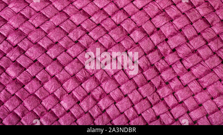 textile panoramic background - weaving of summer straw hat from purple toyo fibers close up Stock Photo