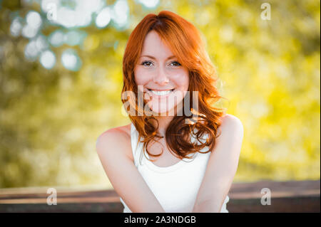 The girl of the sun. Beautiful cheerful girl smiling. Red hair. positive emotion. life is beautiful. Stock Photo