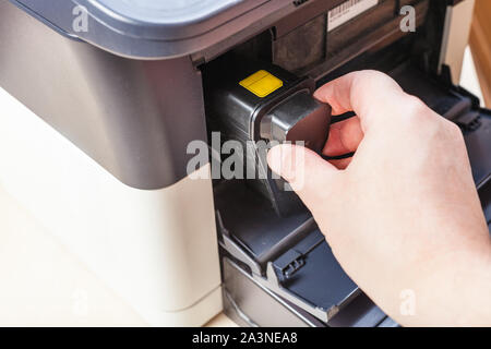 replacement of toner cartridge in laser multi function device in office Stock Photo