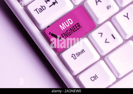 Handwriting text Mud Engineer. Conceptual photo liable for making mixture of fluids used in drilling process White pc keyboard with empty note paper a Stock Photo