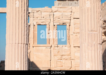 An old deteriorating building with open windows with a bright blue sky in the background. Stock Photo