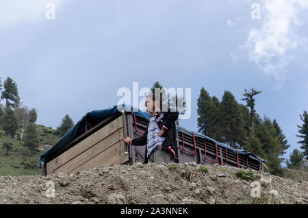 Close-up of driver waiting outside his truck for the traffic congestion to clear on Zoji La Pass, Srinagar - Leh Highway, Jammu and Kashmir, India Stock Photo