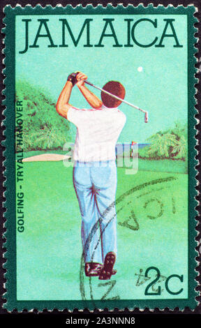 Golf player on jamaican postage stamp Stock Photo
