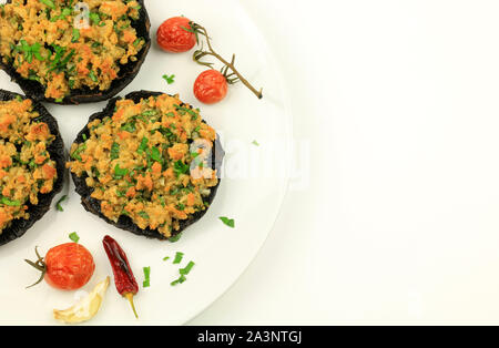 Portobello mushroom caps stuffed with cheese on white background. Top view Stock Photo