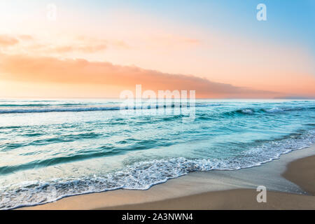 Colorful ocean wave, sea water. Sunset light and beautiful clouds on background Stock Photo