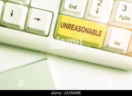 Writing note showing Unreasonable. Business concept for Beyond the limits of acceptability or fairness Inappropriate White pc keyboard with note paper Stock Photo