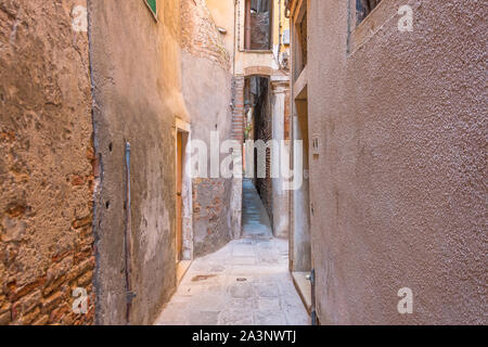 The narrowest street sight in the city of Venice is Calle varisco. Stock Photo