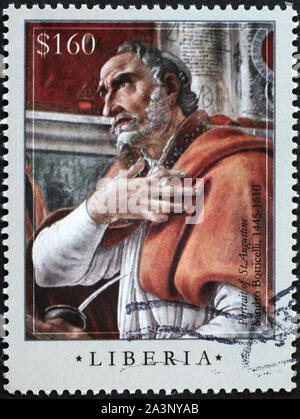 Portrait of St.Augustine by Botticelli on postage stamp Stock Photo