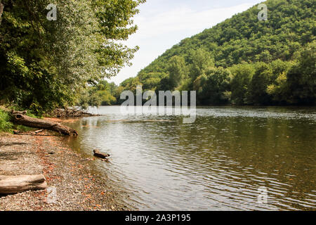trees reflecting in water of river dordogne in aquitaine, Perigord noir, France Stock Photo