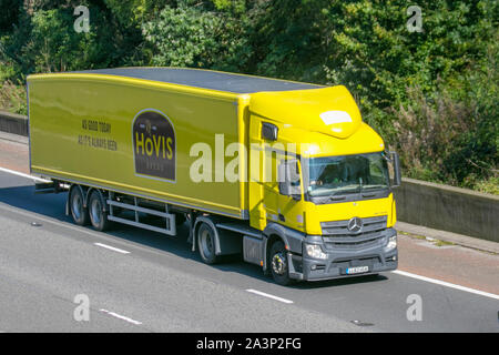 Hovis; Bulk Haulage delivery trucks, haulage, lorry, transportation, truck, cargo, Mercedes-Benz vehicle, delivery, transport, industry, supply chain freight, on the M6 at Lancaster, UK Stock Photo