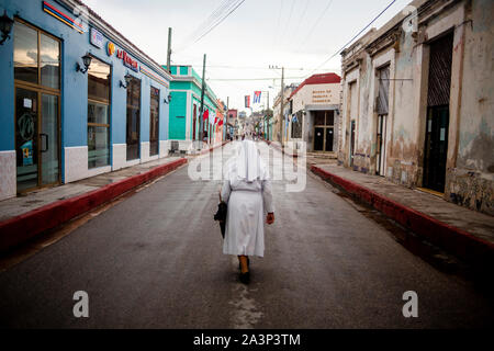 A nun walks the streets of Gibara, a municipality in eastern Cuba. Stock Photo