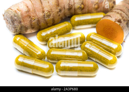 Curcuma capsules with turmeric root Stock Photo