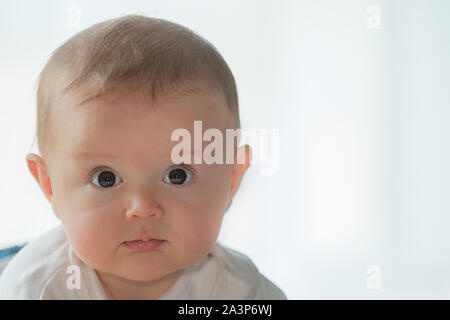 Portrait of cute litte baby girl with big blue eyes Stock Photo