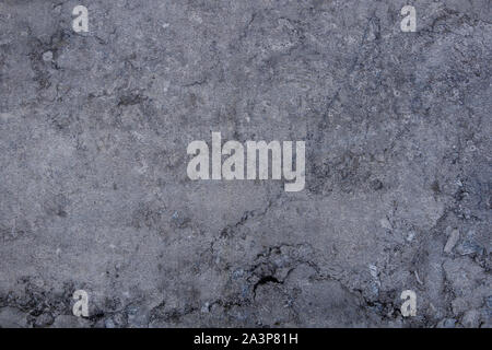 White and grey granite, limestone, or travertine surface with random black organic natural deep bumpy scratch pattern on surface. Stock Photo