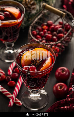 Hot cranberry mulled wine with oranges, anise and cinnamon Stock Photo