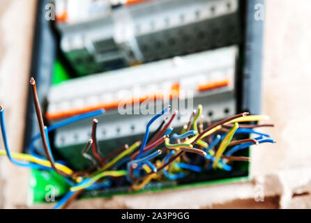 The electric wires are sticking out of the switch box. Stock Photo