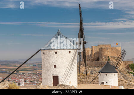landscape in the spanish municipality of Consuegra with two old windmill and the castle of la Muela in the background on a summer day with cloudy sky Stock Photo