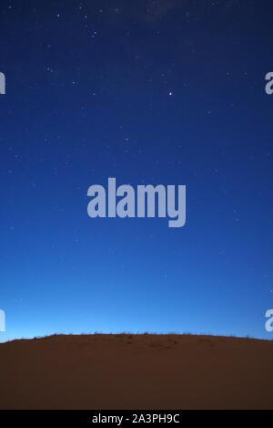Nightfall on the desert. The first stars can be seen in the deep blue sky. Stock Photo