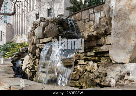 Stairway and man made waterfall at the River Walk, also known as the Passeo del Rio, a network of walkways along the banks of the San Antonio River, one story beneath the streets of Downtown San Antonio, Texas Stock Photo