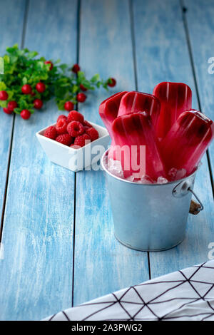 Raspberry popsicles on ice Stock Photo