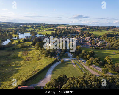 Aerial views of Ripley Castle in Harrogate, North Yorkshire on a partly cloudy evening Stock Photo