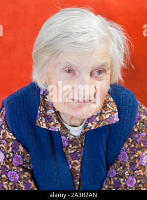 Old lonely woman staying alone at home Stock Photo