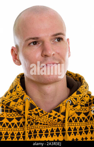 Face of young handsome bald man thinking while looking up Stock Photo