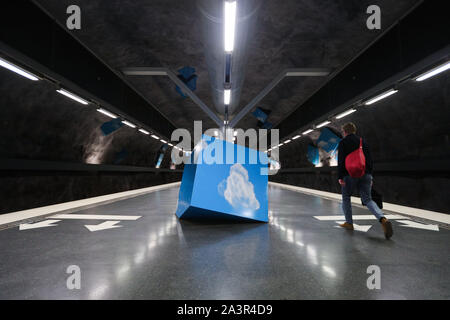 Stockholm, Sweden. 8th Oct, 2019. A passenger walks in the Solna Strand metro station in Stockholm, Sweden, Oct. 8, 2019. Till now, Stockholm's subway system consists of one hundred stations, each with unique art on its platform, walls or waiting hall. Since 1957, artists have been greatly involved in the building of new stations, and they also added beautiful statues, murals, and installations to the older stations. Credit: Zheng Huansong/Xinhua/Alamy Live News Stock Photo