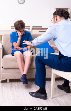 The internet addicted boy visiting male doctor Stock Photo