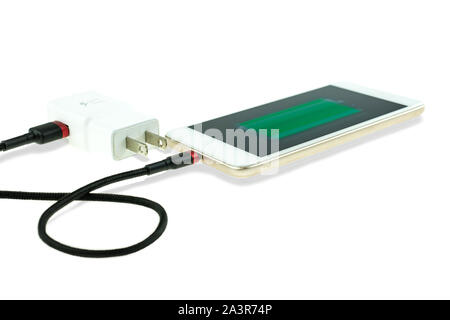 Adapter smart phone charger at plug in power outlet at white background Stock Photo