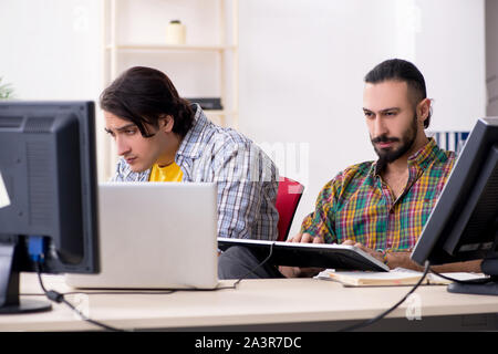 The two it specialists working in the office Stock Photo