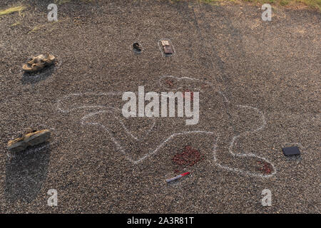 Crime scene chalk outline of victim dead body on Road with blood and evidences, Concept of murder investigation Stock Photo