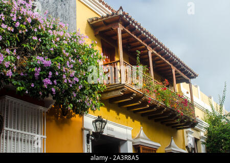 Typical charming balconies with flowers in the Walled City of Cartagena Stock Photo